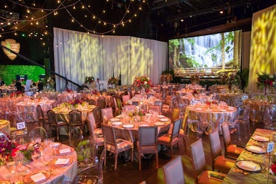 EMT Productions used the Wolf Trap logo and tree-patterned gobos in shades of green and blue to add an outdoor element to the draped walls of the downstage dinner area.