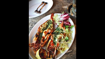 Wood-grilled giant prawns with garlic herb butter and grilled lemon.
