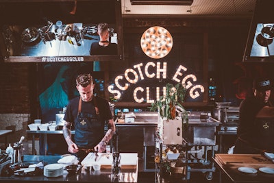 At night, the pop-up turned into the speakeasy-style Scotch Egg Club. The cook-off area had a marquee sign and a mirror that reflected the chefs' cooking area.