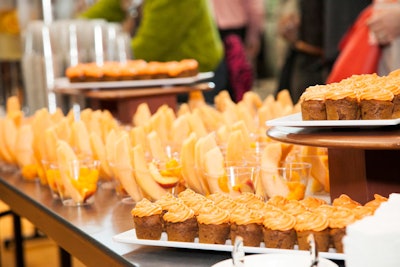 The conference’s color theme carried through to snacks served at breaks. Cups of cantaloupe and peaches, cupcakes with orange frosting, Cheetos, Orange Crush soda, and carrots with dip are some of the orange-hued bites that are offered.