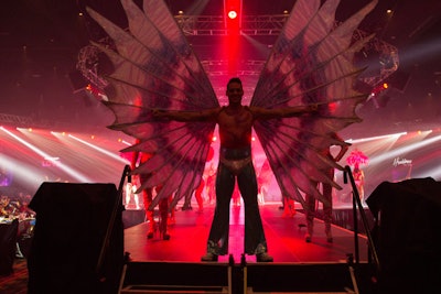 A variety of elaborately costumed entertainers performed on stages around the ballroom as guests arrived.