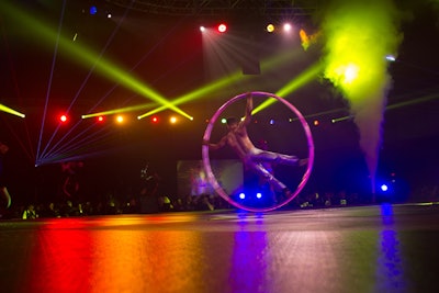 Rainbow-colored lighting filled the ballroom as a variety of acrobats and dancers performed on the main stage and several smaller stages around the perimeter.