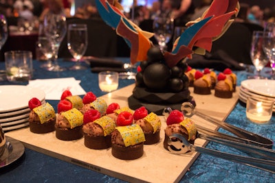 For desserts, guests enjoyed individual servings of chocolate tarts with passion-fruit curd filling. The curved yellow square on top was made of white chocolate colored yellow and painted with a variety of bright colors.