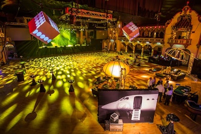 Last year, Groupon hosted a “007”-theme holiday party at the Aragon Ballroom in Chicago. Event Creative decked the venue with James Bond-inspired decor. One of the evening’s interactive activities, or “missions,” was to snap a photo in front of a step-and-repeat featuring a spy plane.