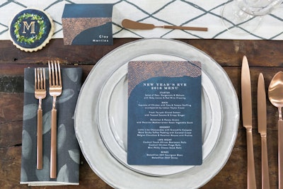 Minted’s new holiday collection features midnight-blue tabletop accessories—including place cards, $41 for 15, and menus, $54 for 15—with a gold accent pattern that works well for a New Year’s Eve event.