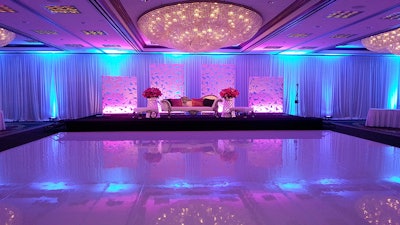 The stage was accented with elegant seating and panels along with Five-Star AudioVisual’s custom drapes.