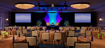 A corporate conference with custom staging and lighting