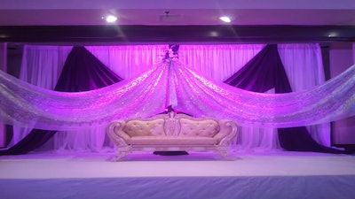 Custom drapes, panels, and lighting were used to accent this royal-themed event.