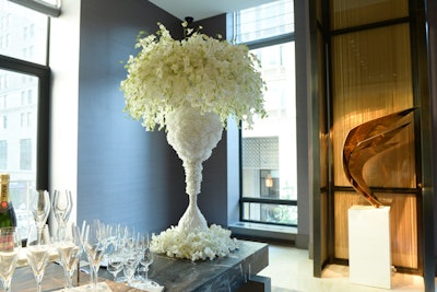 In the pre-function space, Bailey placed two towering floral arrangements on either side of a champagne bar.