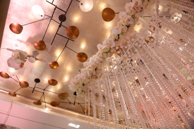 Rows of crystals topped by white orchids contrasted with the ballroom's modern sculptural light fixtures.