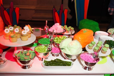 A dessert bar popped in coordinating colors: bold green, pink, and orange.