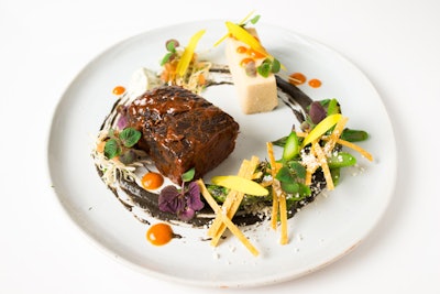 Slow-cooked short rib with jalapeño con queso tamale, huitlacoche puree, Modelo mole, cabbage slaw, and lime crema, by Cloud Catering & Events in Long Island City, New York