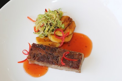 Beer-braised pork shoulder, served with fried tostones, sprout salad, and a peach-I.P.A. sauce, by Brix Catering & Events in Chicago