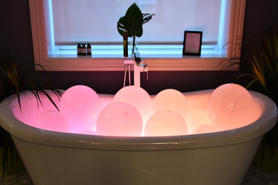 #GiltLife House's October 6 travel event had a Bermuda theme, with decor that included glow-in-the-dark balloons that filled the bathtub with a pink and orange sunset color. The tub provided another popular photo op for guests.