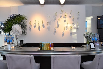 The bar area, which offered BluePrint juice shots, featured a backdrop decorated with florals placed in hand sculptures provided by Interior Illusions.