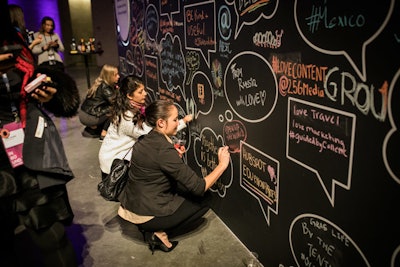 Organizers set up a large blackboard and provided chalk so attendees could share their impressions of the event with one another.