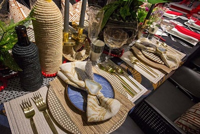 At a table from DL Couch designed by Harken Interiors, woven textures were juxtaposed with patterned napkins; leafy plants, feathers, and stones added a natural feel.