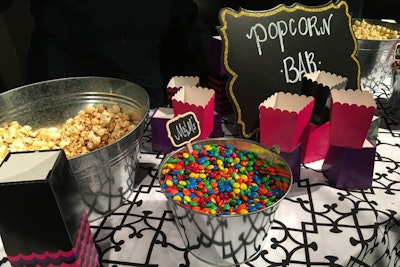 Guests could build their own popcorn bag with a choice of three flavors—plain, cheese, and caramel corn—and a variety of candy toppings including gummy bears, Whoppers, Milk Duds, and M&Ms.
