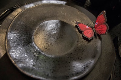 Bright red butterflies added spots of color to the booth—and to place settings.