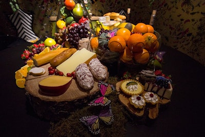 The bright spread comprised bowls of fruit, charcuterie on a slice of tree trunk, and tarts and pies.