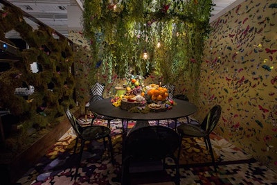 A butterfly motif also appeared in a table Roche Bobois designed with Kaufman Segal Design for Modern Luxury Interiors Chicago. The space had a giant, leafy chandelier that hung low over a picnic-style spread.