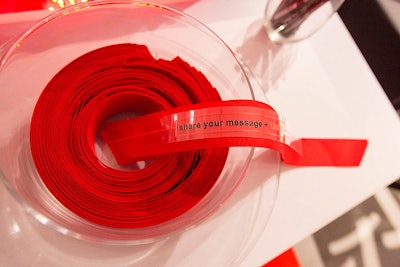 Guests could take a piece of red ribbon, write a message of hope, and affix it to the giant-red-ribbon centerpiece.