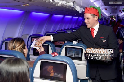 The children boarded a decorated Delta flight that taxied them to the hangar. The plane featured holiday decor and flight attendants dressed as elves who handed out chocolate cookies from Christmas 'stockings.'