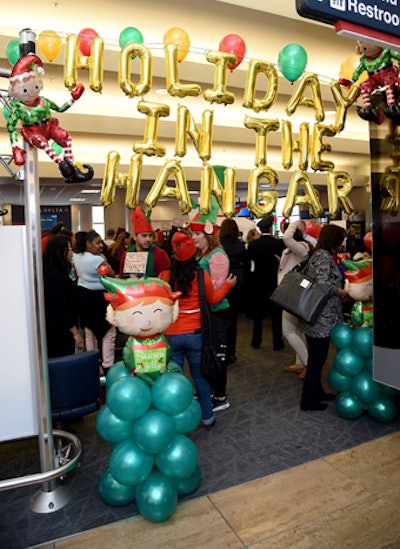 The entrance to the event, which included the event name, was created with holiday-theme balloon decor.