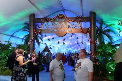 Leis hung from a set piece decked with the film's title, and surrounded by lush foliage.