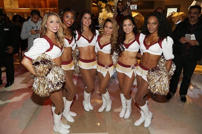 Washington Redskins cheerleaders posed for photos and led an employee parade through the resort with the help of the Redskins marching band.