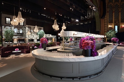 A curving marble bar created a bistro vibe. Jeff Leatham, whose floral designs famously deck the Four Seasons Hotel George V lobby in Paris, created pink flower arrangements that popped within the otherwise subdued space.