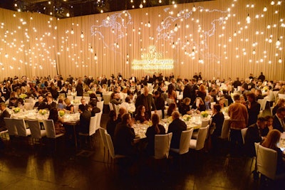 In November, Rolex feted the 40th anniversary of its Awards for Enterprise in Los Angeles. The presentation took place at the Dolby Theatre, and afterward a large screen lifted to reveal the dining area, which was set up right on the Dolby’s stage. Producer and designer Bounce-AEG played up the fact that the dinner took place on an actual theatrical stage, choosing Edison lightbulbs as the major design feature: Suspended at all different heights over diners, the lights resembled a starry sky. The decor element added drama while being simple and unfussy.