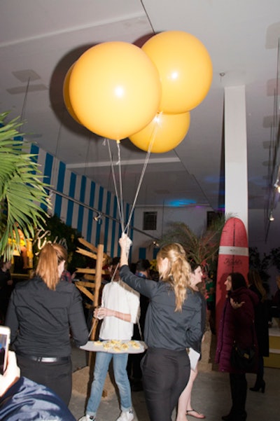 Pinch Food Design provided the catering, which included taleggio cheeseburgers, chicken waldorf salad in an apple cup, watermelon popsicles, and yellowtail poke, which was presented via balloons that were steered like a kite by the server.