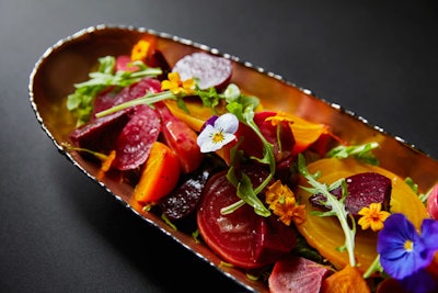 Delicate edible flowers will top a colorful roasted beet salad.