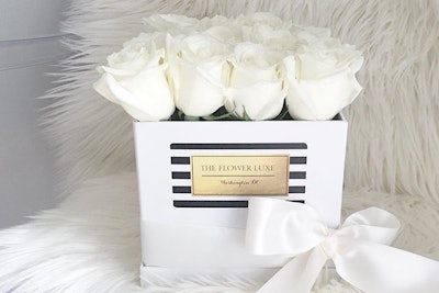 The Flower Luxe's Classic Luxe flower boxes can contain white, yellow, pink, purple, or red roses, which can be arranged in patterns. The easy-to-transport arrangements can delivered locally same-day.