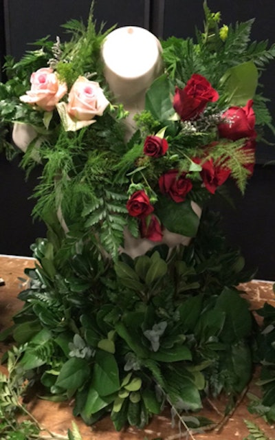 A team of volunteers created the fashion out of flowers for the bust forms that adorned the check-in tables as well as a full floral dress inside the main entrance.