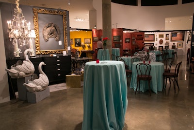 Willen used a mix of the cafe-style seating and highboy tables draped in the same Tiffany-blue linens throughout the three floors of the antiques exhibits.