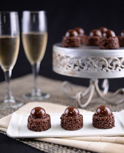 Puff 'n Stuff Catering’s version of a financier features an almond-chocolate sponge cake coated with dark chocolate flakes and topped with a chocolate hazelnut crémeux.