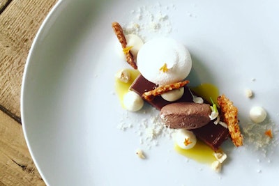 The spiced chocolate pate creation from Truffleberry Market features a champagne and Valencia orange reduction and is topped with vanilla bean-mascarpone whipped cream, cardamom meringue, flake-salted hazelnut brittle, and shaved hazelnut snow.