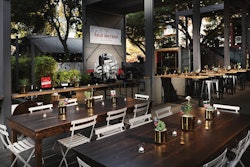 A snazzy dining set-up at Container Bar, featuring our French 75 chairs and Harvest Table.