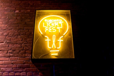 Neon signage is placed around the pedestrian-friendly neighborhood.