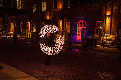 Vendors can walk through the neighborhood selling merchandise related to the festival including lights that spell out the event's title.