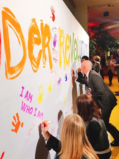 Guests used paint and markers to write, draw, and leave handprints on the wall after the screening.