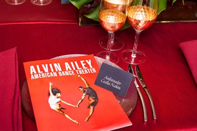 DC Rental draped the all-rectangular dinner tables in five different styles of red linens with accents of silver and gold.