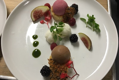 This raspberry and chocolate semifreddo dessert from Brûlée Catering by chef Jean-Marie Lacroix comes garnished with a financier, champagne sorbet, mint syrup, and a sesame tuile.