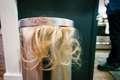 Blond hair from what appeared to be a human head spilled from a trash can.