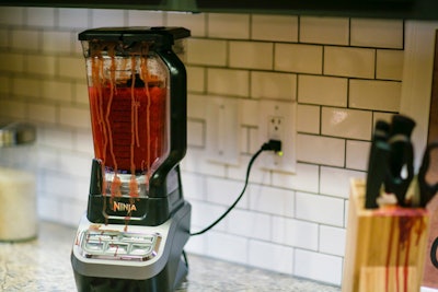 A bloody blender and knives were part of a kitchen setup.