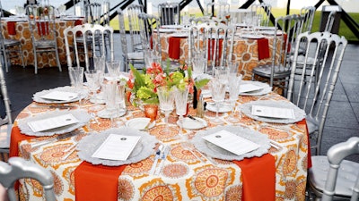 Vibrant tangerine mixed with the elegance of silver created a beautiful punch of color at this dinner.