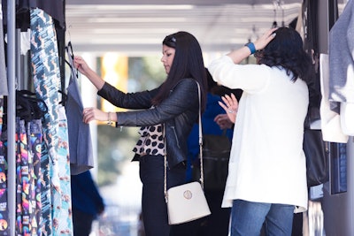 A shipping crate serves as a pop-up shopping experience at each event. Guests can research and purchase the displayed products on the Zappos website using iPads provided by the brand.