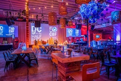 Wooden tables, fishing nets, and blue-water projections helped create a bayside environment inside Dock5.